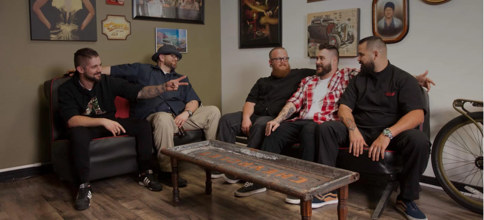 Five members of the barber shop crew relaxing on a couch